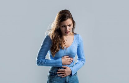 Endometriosis Research Study. Woman with hand on stomach because nausea, painful disease feeling unwell. Ache concept. Stomach pain and others stomach disease concept. Woman suffering from abdominal pain. Woman stomach ache Woman with hand on stomach because nausea, painful disease feeling unwell. Ache concept. Stomach pain and others stomach disease concept. Woman suffering from abdominal pain. Woman stomach ache.